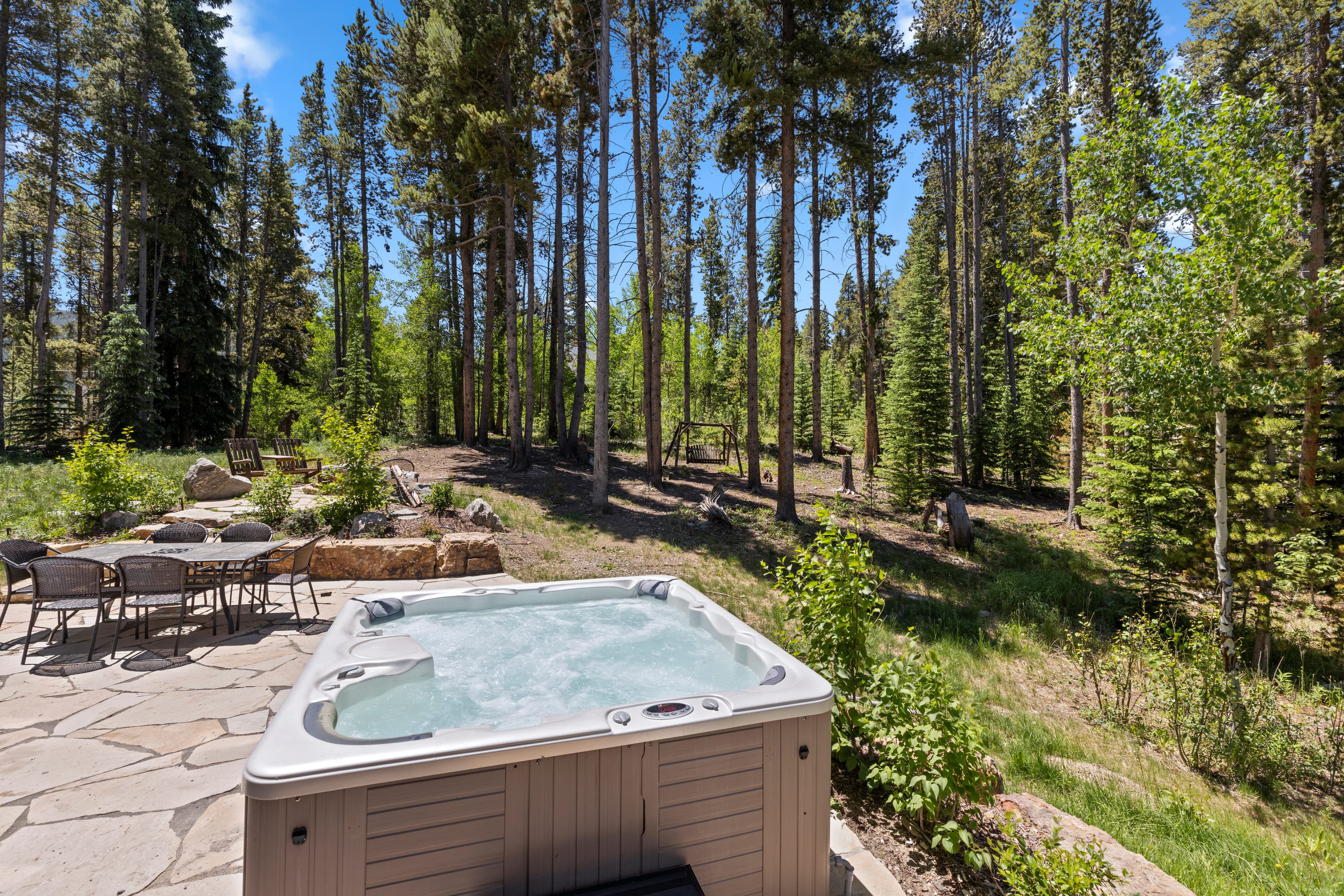 Private hot tub surrounded by pine trees