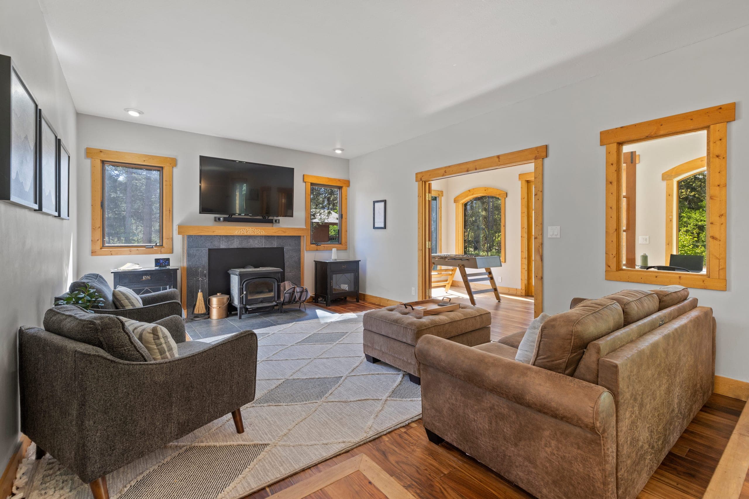 Main-level living room at Lodestone Retreat, with sofas gathered around the wood-burning stove